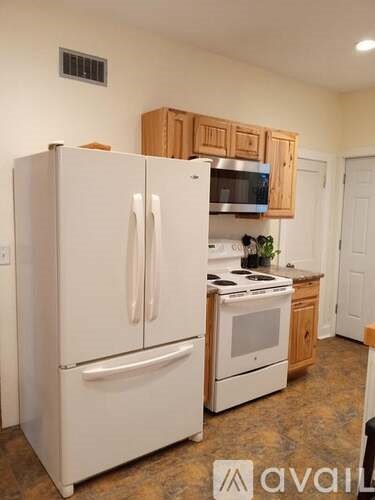A kitchen with a white refrigerator and a white oven.