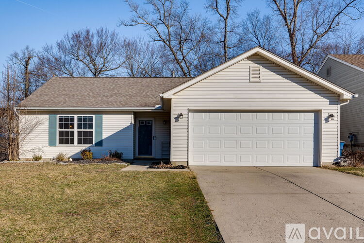 A house with a white garage door and a blue window.