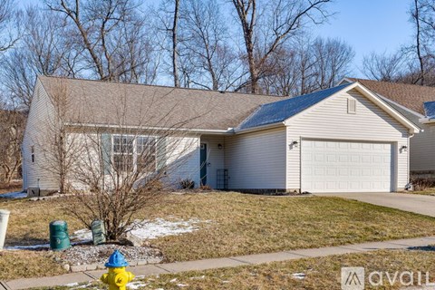 A house with a garage and a yellow fire hydrant in front.