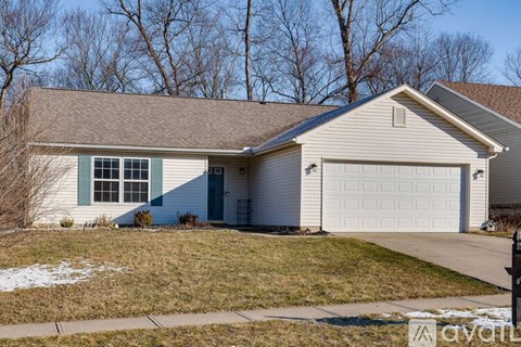 A house with a white garage door and a brown roof.