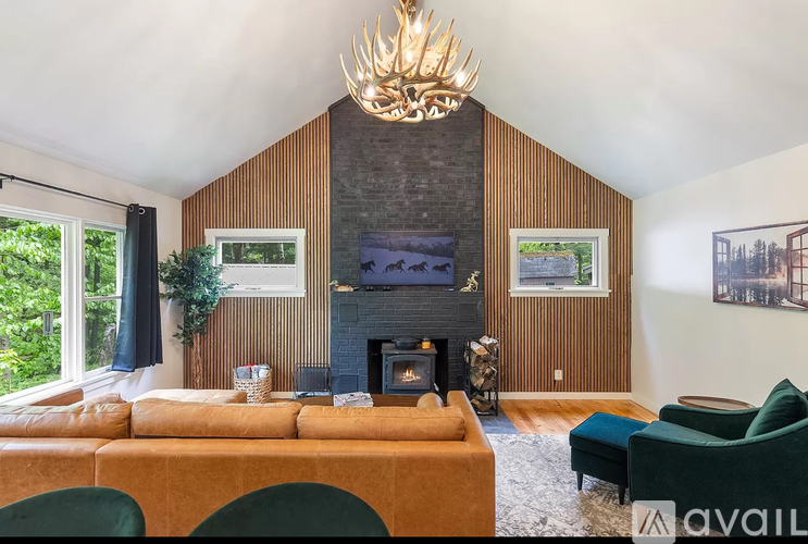 A living room with a fireplace and a large chandelier.