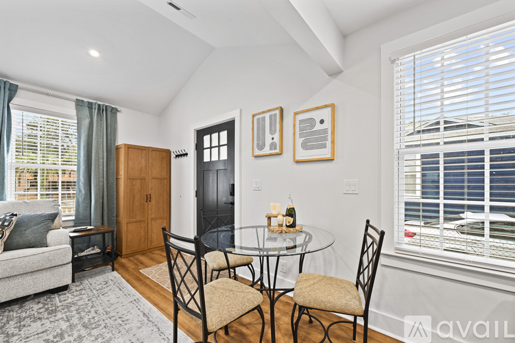 A dining room with a glass table and chairs.