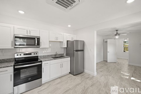A kitchen with white cabinets and stainless steel appliances.
