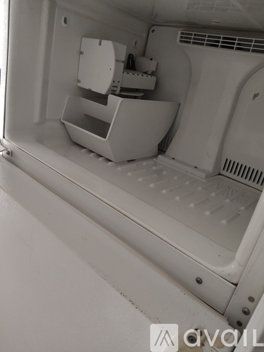 A white refrigerator with a water dispenser on the left side.