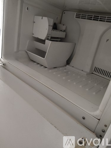 A white refrigerator with a water dispenser on the left side.