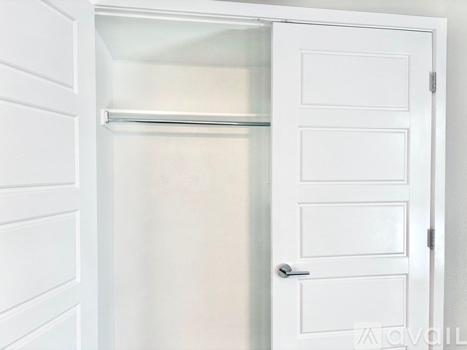 A white door with a handle and a window above it.