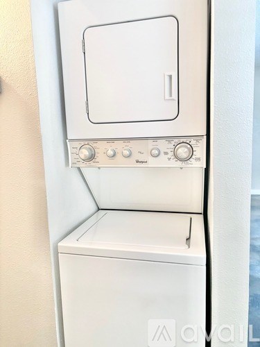 A white oven with a door and knobs on the front.