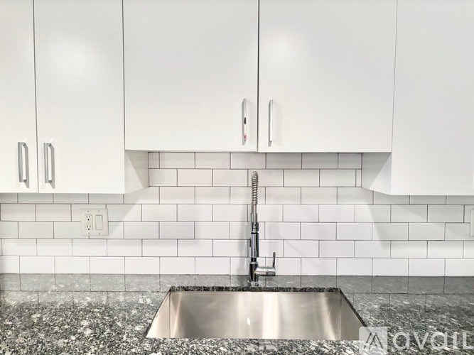 A kitchen with a sink and cabinets.