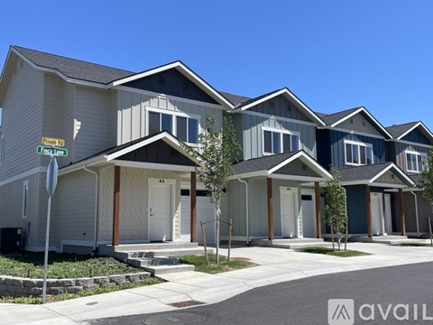 A row of houses with the first one on the left being blue and the second one being grey.