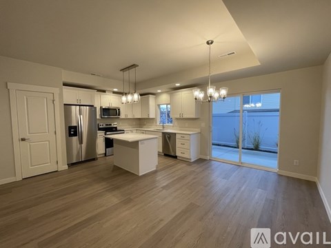 A spacious kitchen with a refrigerator, oven, and microwave.