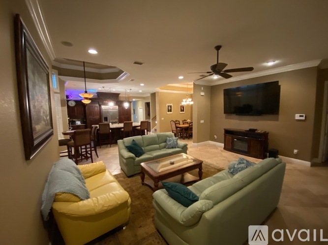 A living room with a yellow chair and a green couch.