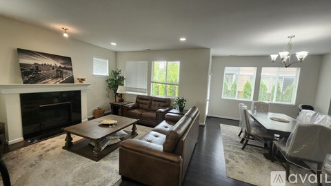 A living room with a fireplace and a large painting on the wall.