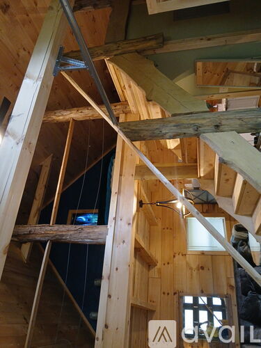 A wooden staircase is being built in a house.