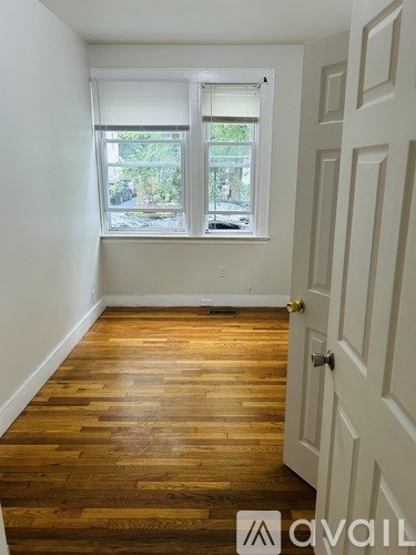 A room with wooden floors and a white door.