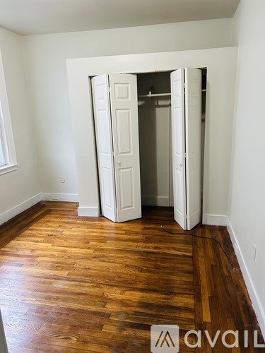 A room with a wooden floor and a white door.