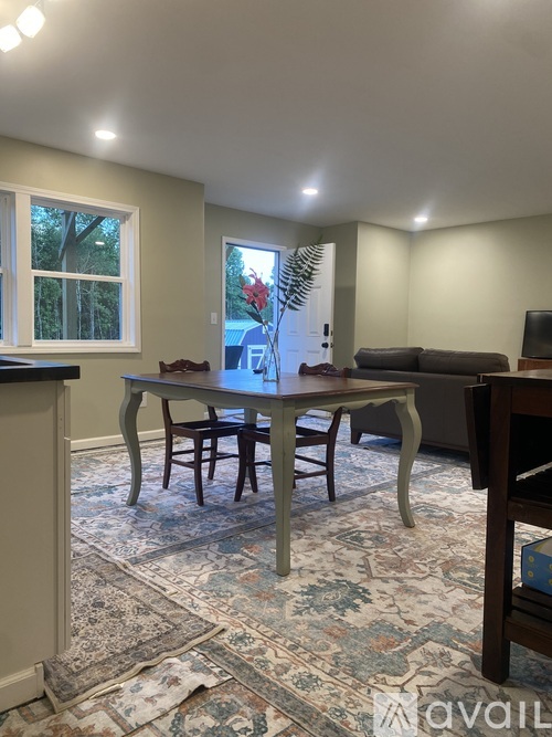 A dining room with a table and chairs.
