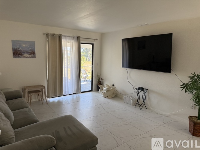 A living room with a dining table and a sofa.