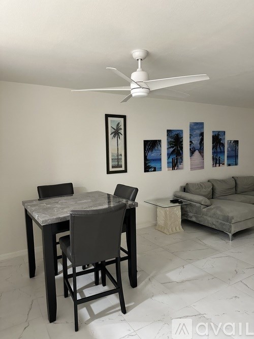 A living room with a dining table and a sofa.