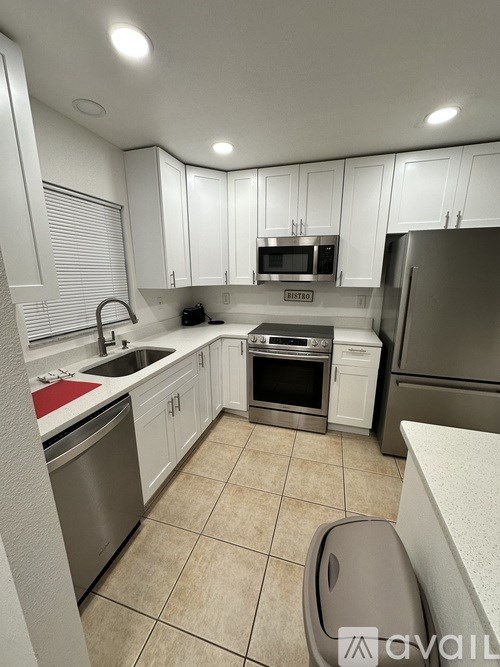 A kitchen with white cabinets and stainless steel appliances.
