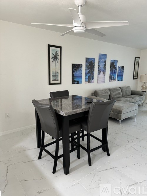 A dining room with a table and chairs.