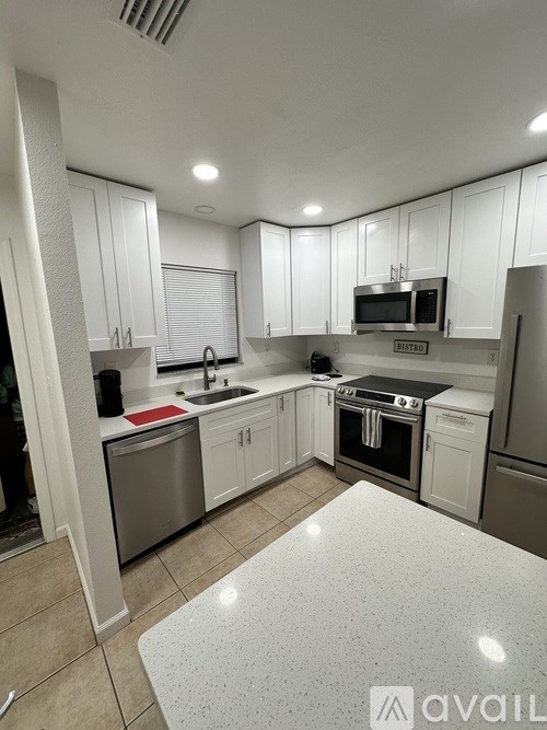 A kitchen with white cabinets and a sign that says "RESTRICTED".
