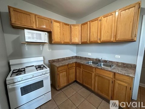 A kitchen with wooden cabinets and a white stove.