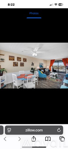 A room with a dining table and chairs.