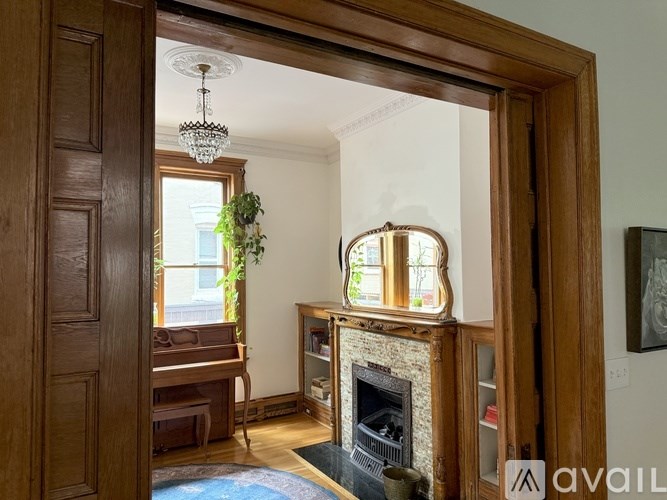 A bathroom with a white sink and a glass shower stall.