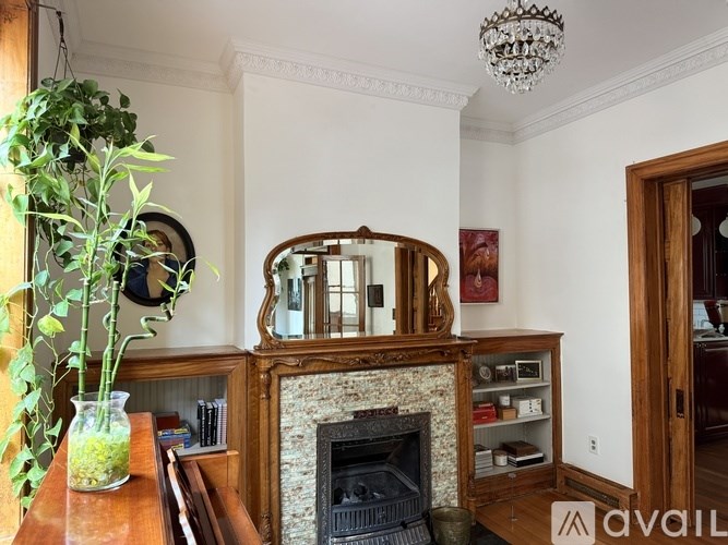 A living room with a fireplace and a flat screen TV mounted above it.