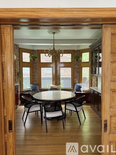 A white shelf with blue shelves inside a white door.