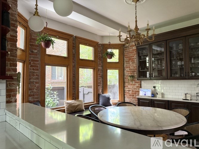 A bathroom with a white toilet, sink, and a mirror.