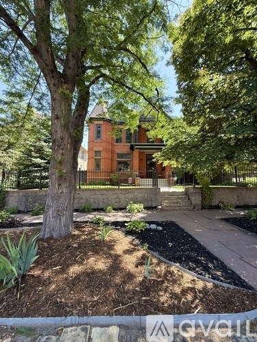 A living room with a fireplace and a white couch.