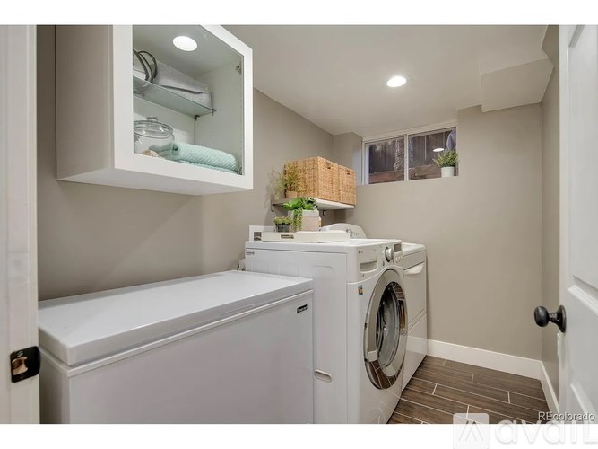 A white washing machine and dryer in a small laundry room.