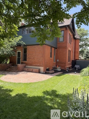 A house with a red brick exterior and a green roof.