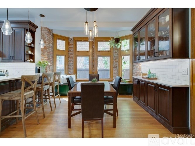 A kitchen with wooden floors and furniture.