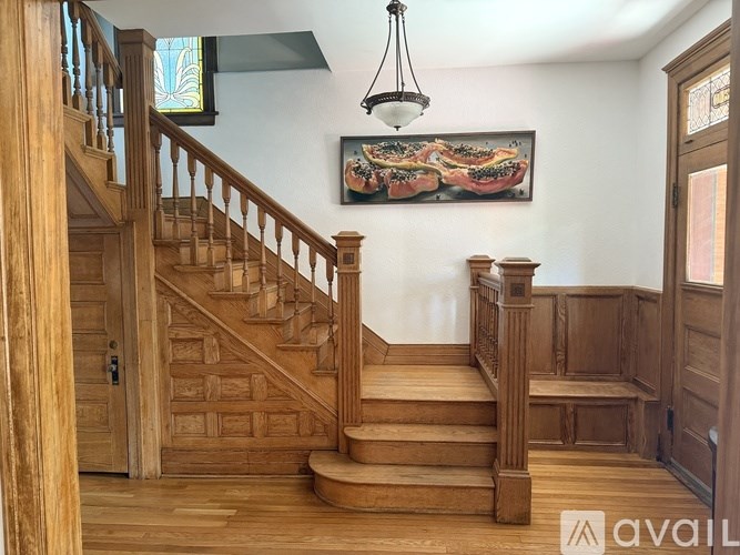 A dining room with a wooden table and chairs.