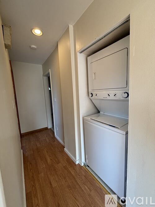 A white oven and fridge in a narrow hallway.