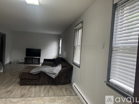 A living room with a brown couch and a flat screen TV.