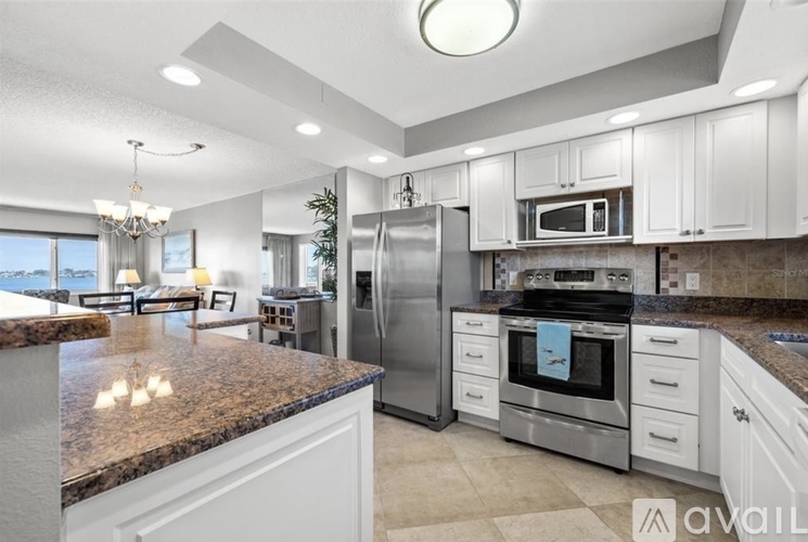 A kitchen with granite countertops and stainless steel appliances.