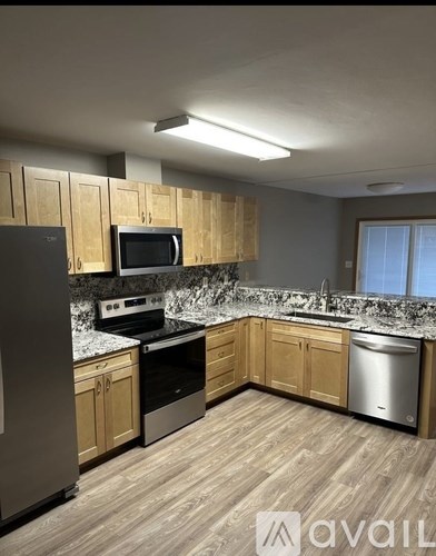 A kitchen with wooden cabinets and stainless steel appliances.