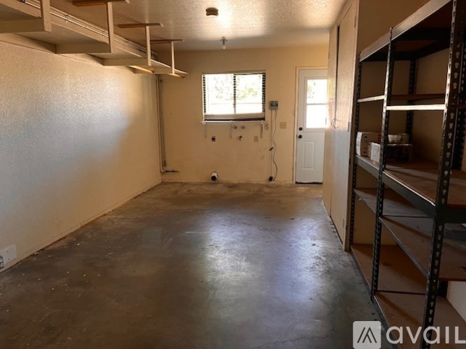 A room with a window and a door is available for rent.