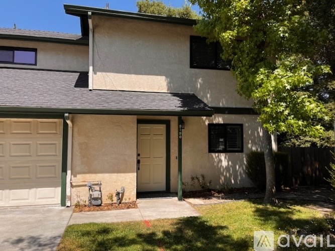 A two-story house with a garage on the left side.