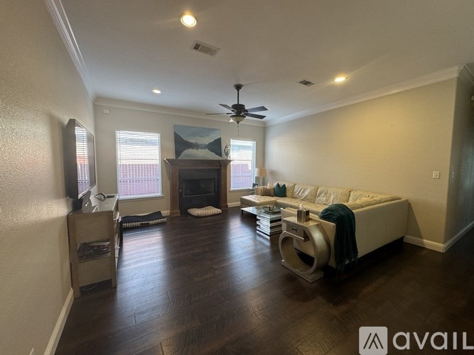 A living room with a fireplace and a television.