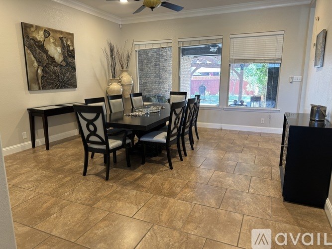 A dining room with a table set for six.