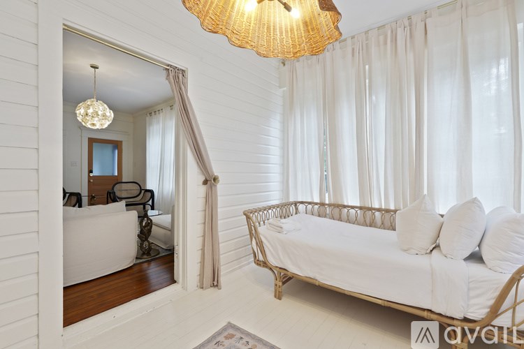 A bedroom with a bed and a chandelier.
