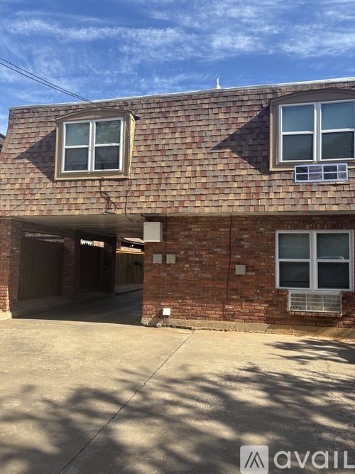 A brick building with a garage door open.