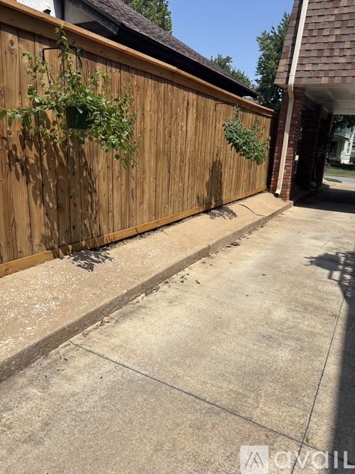 A wooden fence with plants growing on it.