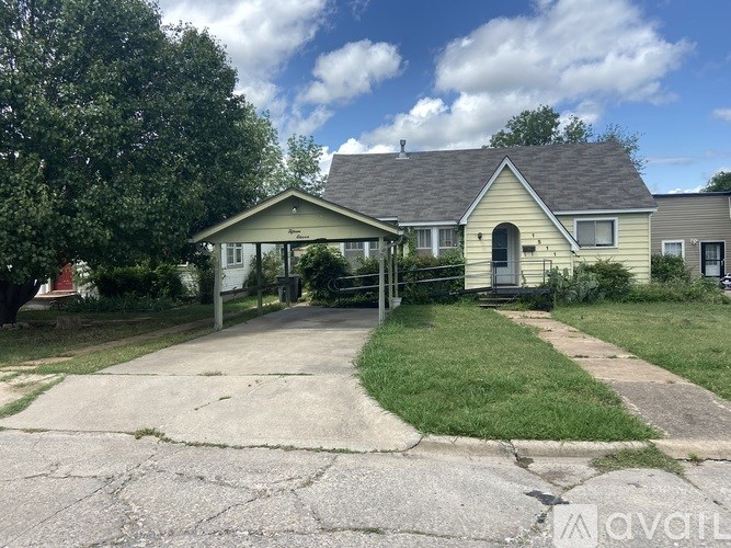 A house with a front yard and a driveway.