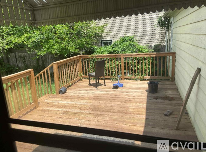 A wooden deck with a table and chairs.