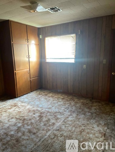A room with wooden walls and a carpeted floor.